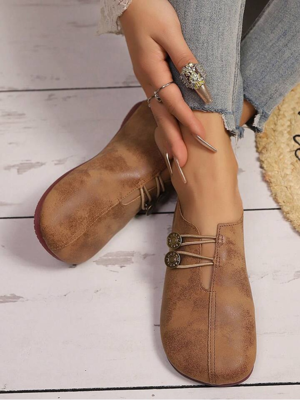 Tan Brown Slip-On Loafers with Decorative Button Accents.